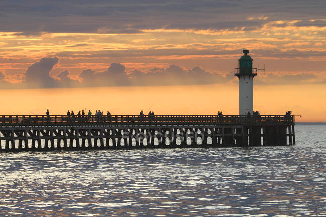 France, North Coast. Calais. The pier over sea water surface at sunset — Stock Photo