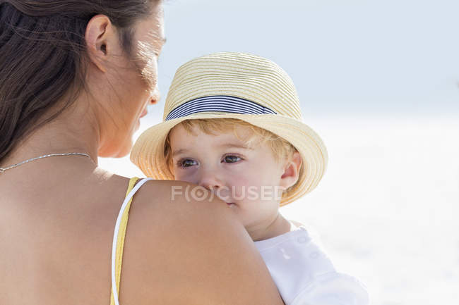 Close-up of woman carrying baby outdoors — Stock Photo