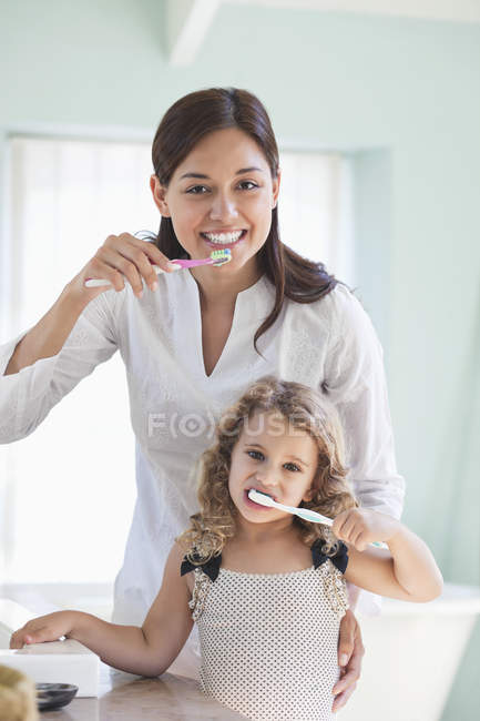 Портрет молодої жінки і дочки чищення зубів — стокове фото