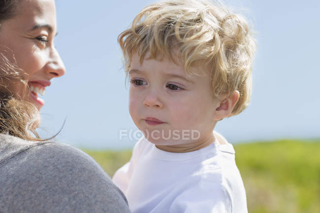 Close-up of happy woman with baby boy outdoors — Stock Photo