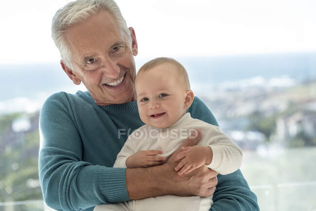 Portrait of happy grandfather with baby granddaughter — Stock Photo