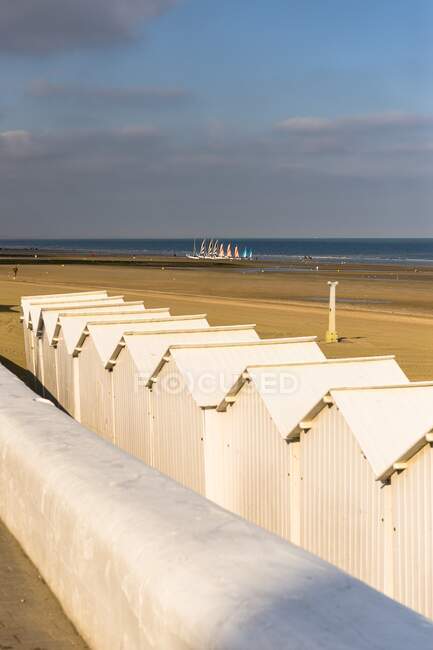 France, Normandy, white beach huts in line on the sand — Stock Photo