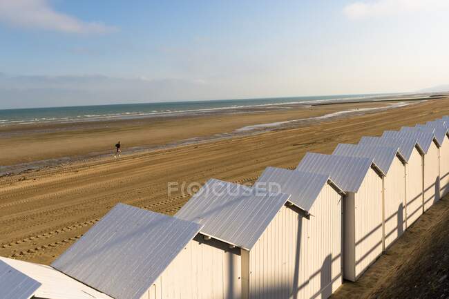 França, Normandia, cabanas de praia brancas em linha na areia — Fotografia de Stock
