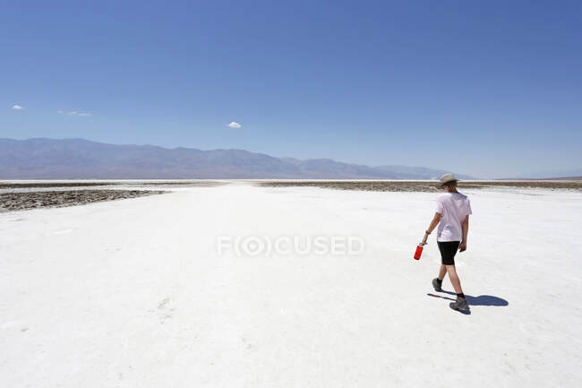 USA. California. Death Valley. Badwater. Sea of ??salt. Tourist (12 years old) during the hike, under the heat. — Stock Photo