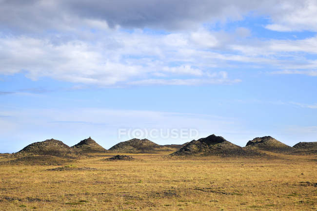 Hills on field under clouds, Iceland, Sudurland. lftaversggar — Stock Photo