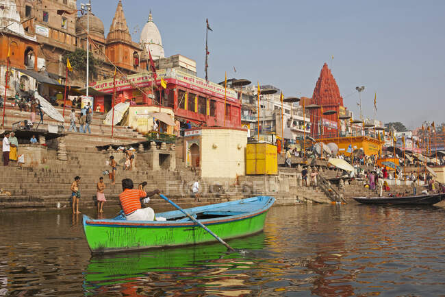 Uomo visto da dietro remare sul Gange lungo i Ghati, Varanasi o Benares, Stato dell'Uttar Pradesh, India — Foto stock