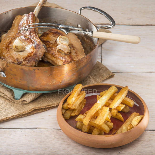 Thick pork chops with French fries — Stock Photo