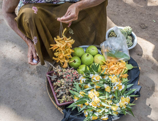 Myanmar, zona de Mandalay, venta de flores en el mercado de la aldea para hacer donaciones a Buda - foto de stock