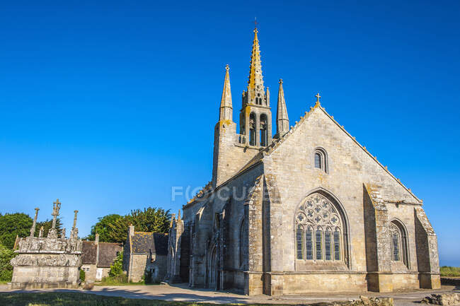 Francia, Bretagna, Baia di Audierne, croce lungo la strada e cappella di Notre-Dame-de-Tronoen (XV secolo) — Foto stock