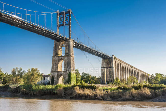 Франция, Charente Maritime, Tonnay-Charentes, подвесной мост (1842, историческое здание) на реке Шаранта, пешеходы и велосипедисты шлюз — стоковое фото