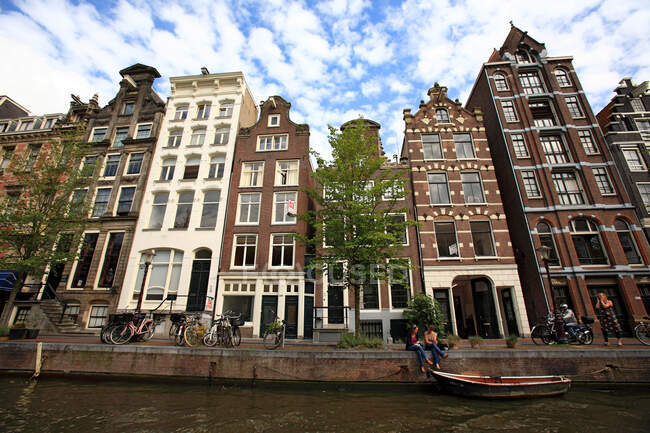 Países Bajos, Holanda Septentrional, Ámsterdam, edificios a lo largo del canal - foto de stock