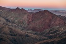 Aerial view of beautiful mountains with beige and pink sky during sunrise in Morocco, Africa — Stock Photo