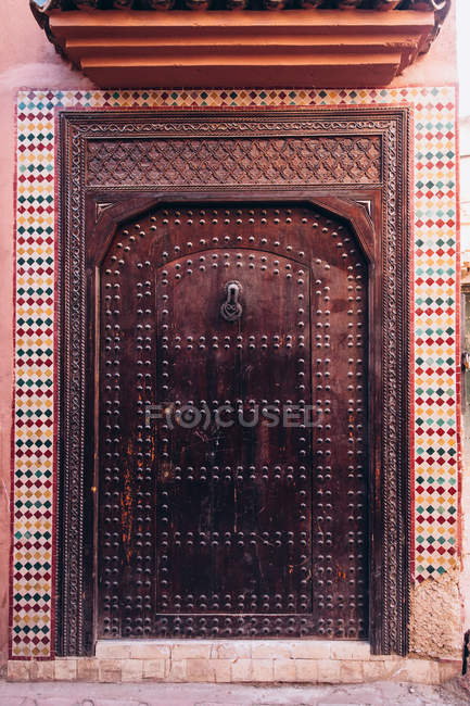Beautiful old wooden door with decorative metal elements and colorful tiles in Morocco, Africa — Stock Photo