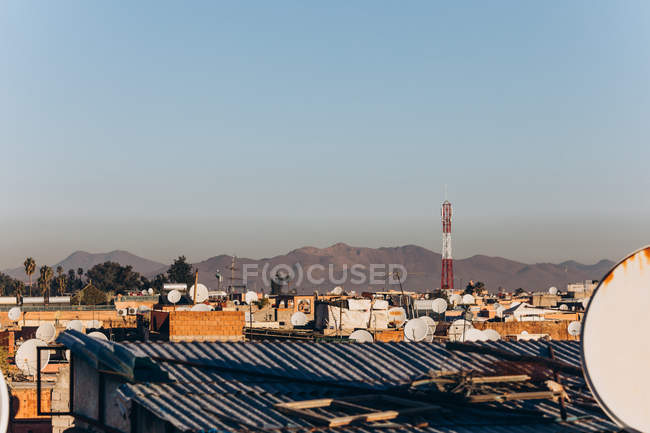 Amazing Marrakesh city view with traditional houses, rooftops and mountains at sunny day, Morocco, Africa — Stock Photo