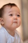 Retrato de adorable asiático bebé mirando lejos en casa - foto de stock