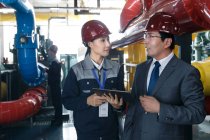 Chinese colleagues working together in the factory inspection — Stock Photo