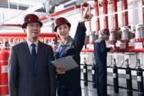 Technical personnel in the factory fire control room inspection — Stock Photo