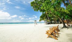 Beach chairs on sand at beautiful boracay beach — Stock Photo