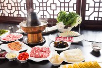 High angle view of various ingredients and copper hot pot, chafing dish concept — Stock Photo