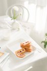 Vista de cerca de sabroso desayuno dulce en la mesa blanca - foto de stock