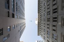 Bottom view of Hong Kong urban architecture and blue sky — Stock Photo