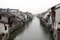 High angle view of buildings near canal at cloudy day, Wuxi, Jiangsu, China — Stock Photo