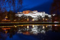 Erstaunliche antike Architektur spiegelt sich in ruhigem Wasser in der Nacht, Tibet — Stockfoto