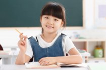 Portrait of a girl sitting in classroom — Stock Photo