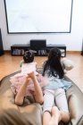Two girls watching TV at home — Stock Photo