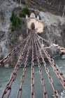Chains above rapid water and ruins on rocky hill at Jindawei, Sichuan, China — Stock Photo