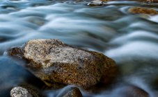 Close-up view of stones in water of rapid stream in Tibet — Stock Photo