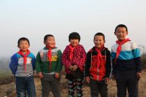 Felici alunni cinesi in piedi insieme e sorridente alla fotocamera all'aperto — Foto stock