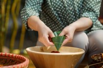 Partial view of woman cooking traditional chinese dish zongzi — Stock Photo