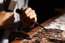 Close-up partial view of man during woodworking engraving at workshop — Stock Photo