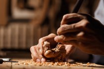 Close-up partial view of male hands during woodworking engraving at workshop — Stock Photo
