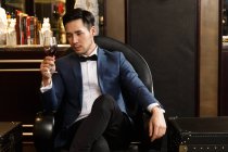 A young man with a red wine glass — Stock Photo