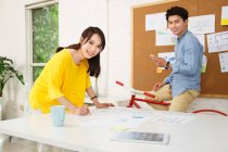 Young man and young woman in design studio — Stock Photo