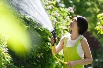 Women in the garden watering the garden — Stock Photo
