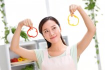 Portrait of young woman cooking in kitchen — Stock Photo