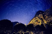 Increíble vista nocturna con montañas, árboles y cielo estrellado, Guizhou Loushanguan - foto de stock