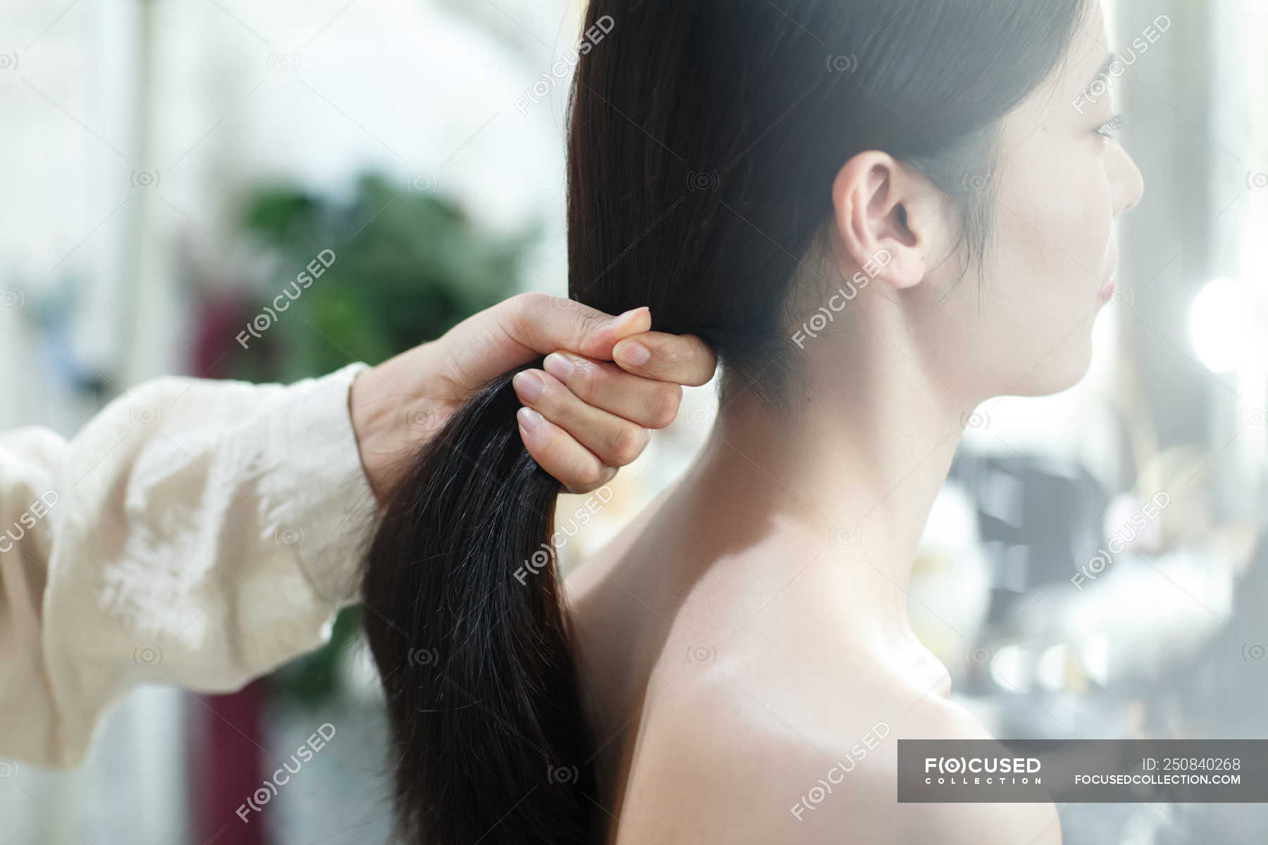Cropped Shot Of Woman Doing Hairstyle To Beautiful Young Asian