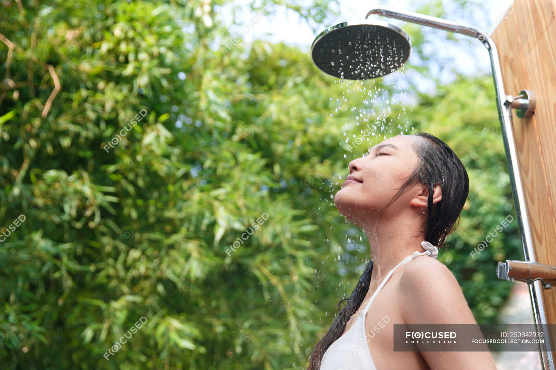 Low Angle View Of Smiling Young Woman In Bikini Taking Shower With Closed Eyes — Enjoying Body