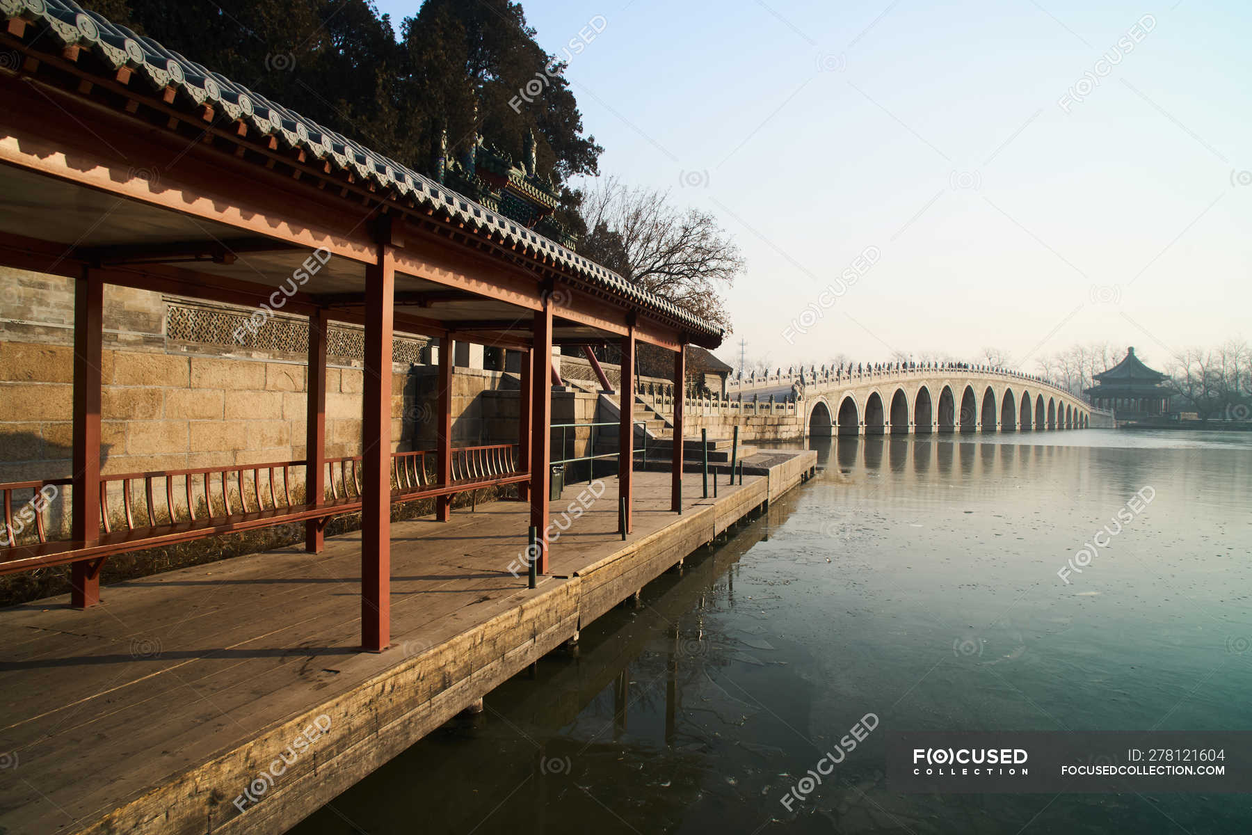 Seventeen hole bridge of The Summer Palace at sunset, Beijing ...