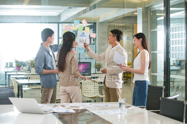 Young asian business colleagues working with papers in office — Stock Photo