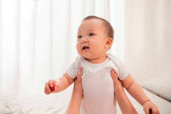 Schnappschuss von Mutter, die entzückend glückliches Kleinkind zu Hause hält — Stockfoto