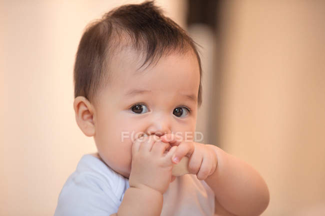 Close-up view of adorable asian infant baby eating at home — Stock Photo