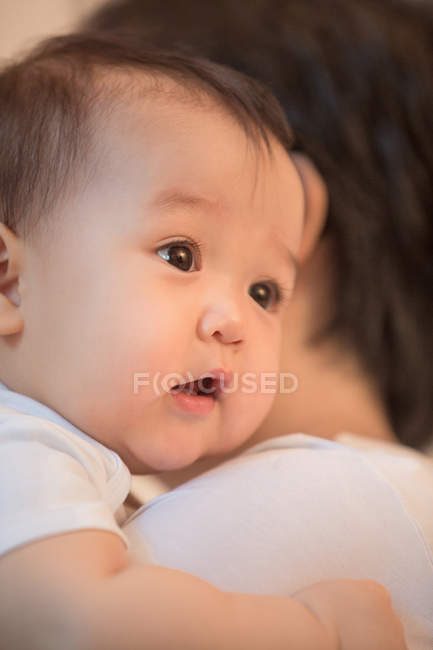 Cropped shot of parent carrying adorable asian infant baby at home — Stock Photo