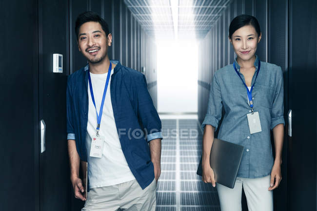 Professional confident technical personnel smiling at camera while working in the maintenance room inspection — Stock Photo