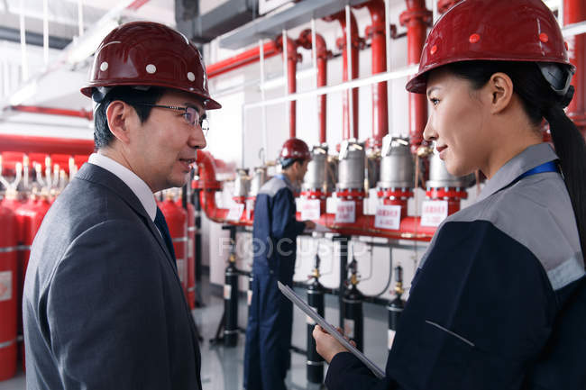 Technical personnel in the factory fire control room inspection — Stock Photo