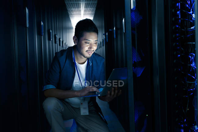Man using laptop computer and working in the maintenance room inspection — Stock Photo